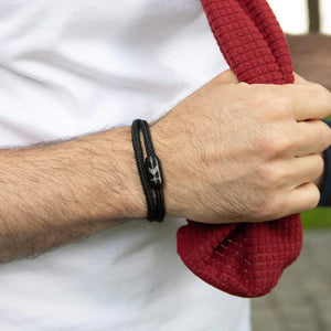 Vertig Magnetic Nautical Paracord Bracelet Black on a man's forearm. Features sleek black rope.