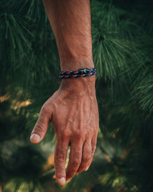 Vertig Magnetic Nautical Paracord Bracelet Blue-Red on a man's forearm. Features bright blue and red rope.