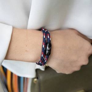 Vertig Magnetic Nautical Paracord Bracelet Blue-Red on a woman's wrist. Stylish, durable outdoor accessory.