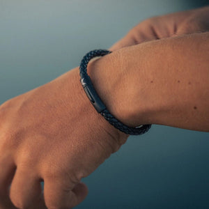 Vertig Leather Bracelet Black on a man's wrist. Accentuates refined style with its understated elegance and expertly crafted slim leather.