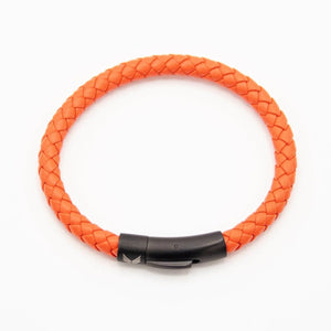 Vertig Leather Bracelet Orange clasped. Demonstrates the seamless and elegant fit of its sleek clasp on the wrist.