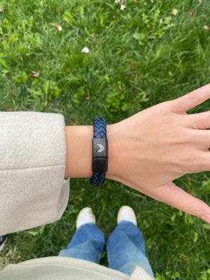 Vertig Magnetic Wide Leather Bracelet Black-Blue on a woman's wrist. Adds a confident, contemporary touch with its bold design.