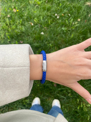 Vertig Magnetic Leather Bracelet Blue (Slim) on a woman's wrist. Adds a refined touch, highlighting its slender profile and genuine blue leather.