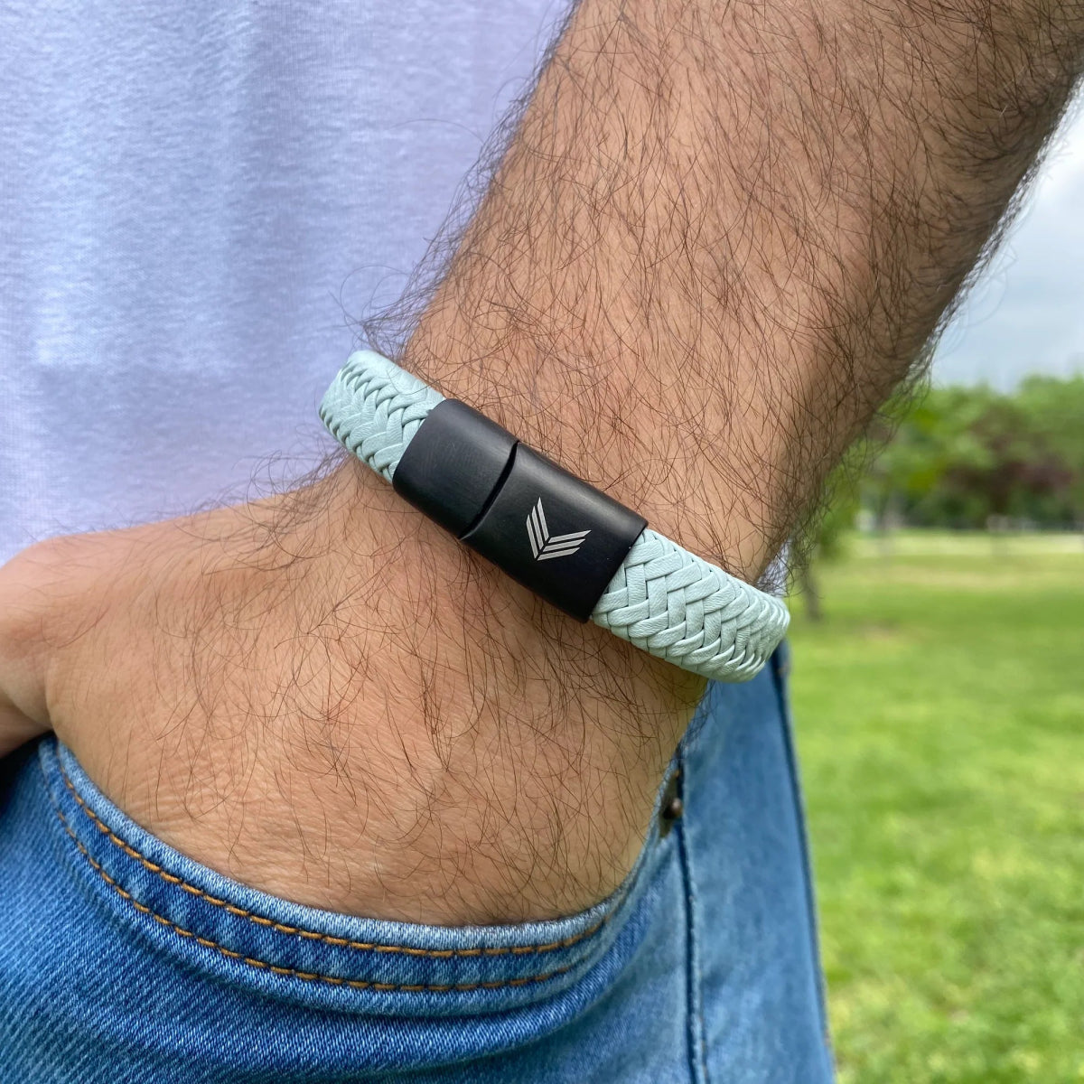 Vertig Magnetic Wide Leather Bracelet Grey on a man&#39;s forearm. Showcases the premium texture of genuine grey leather and comfortable wear.