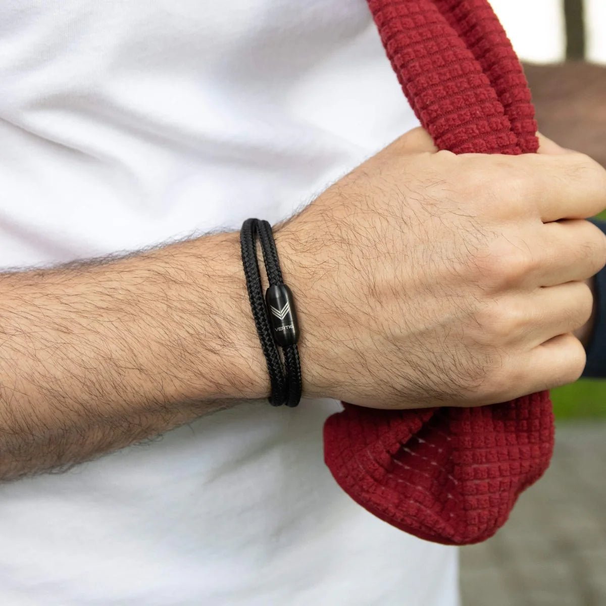 Vertig Magnetic Nautical Paracord Bracelet Black on a man&#39;s forearm. Features sleek black rope.