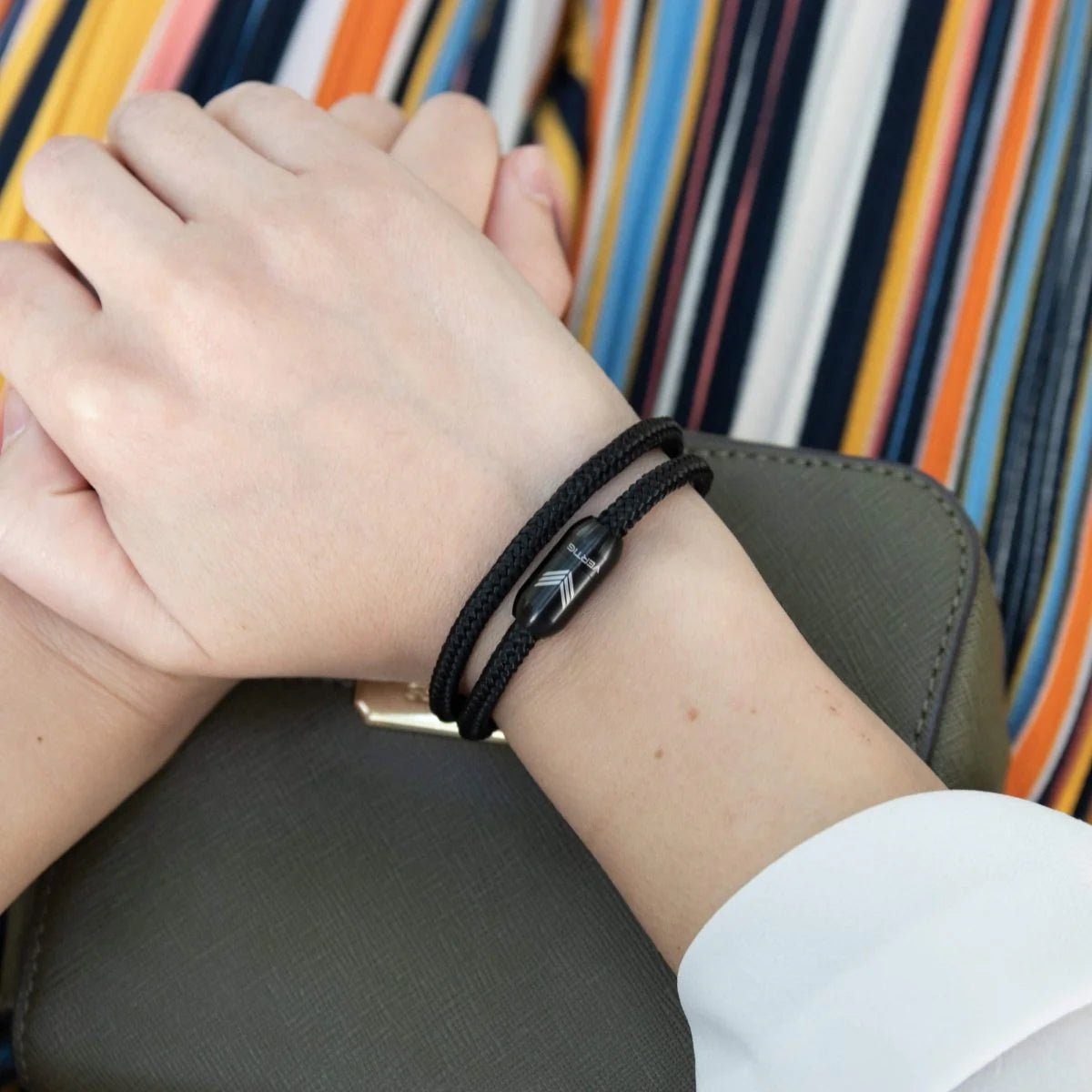 Vertig Magnetic Nautical Paracord Bracelet Black on a woman&#39;s wrist. Stylish, durable outdoor accessory.