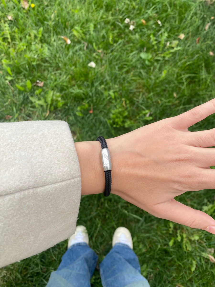 Vertig Magnetic Nautical Paracord Bracelet Black (Slim) on a woman&#39;s wrist. Highlights its slender profile, adding a sleek modern touch.