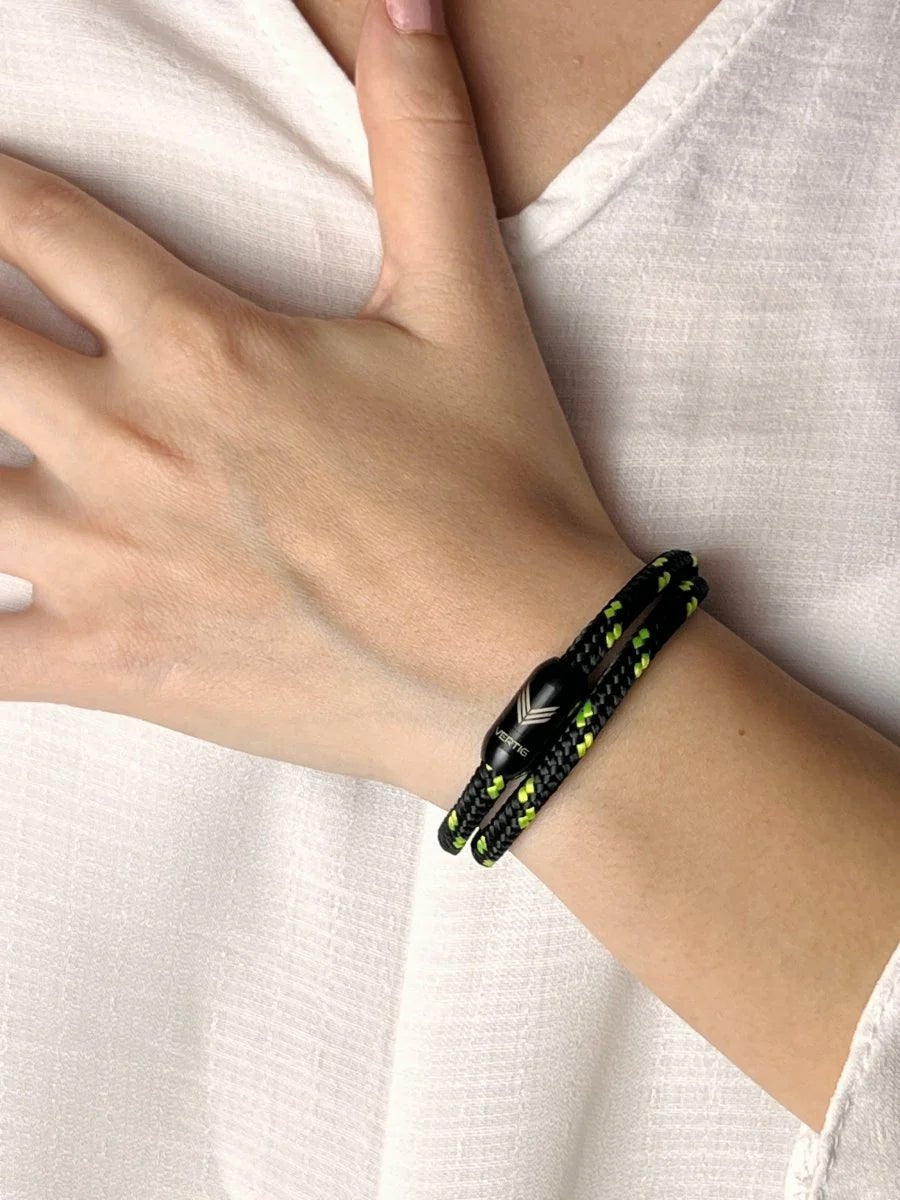 Vertig Magnetic Nautical Paracord Bracelet Black Neon on a woman&#39;s wrist. A striking accessory for modern, active wear.