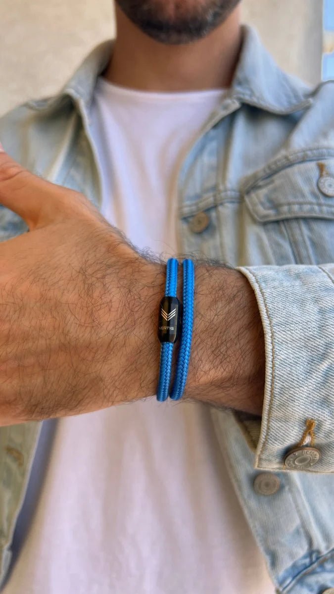 Vertig Magnetic Nautical Paracord Bracelet Blue on a man&#39;s wrist. Adds a timeless, sporty statement.