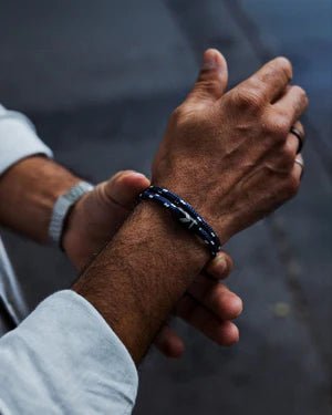Vertig Magnetic Nautical Paracord Bracelet Blue-White on man's wrist. Lightweight, comfortable, and trendy.