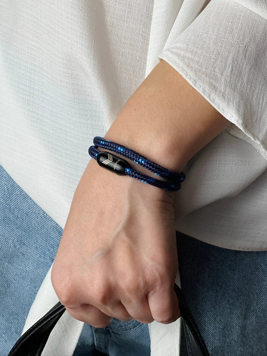Vertig Magnetic Nautical Paracord Bracelet Dark Blue on a woman&#39;s wrist. Fashionable dark blue accessory.
