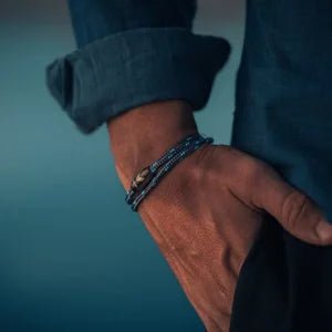 Vertig Magnetic Nautical Paracord Bracelet Dark Blue on a man's forearm. Features sleek dark blue rope.