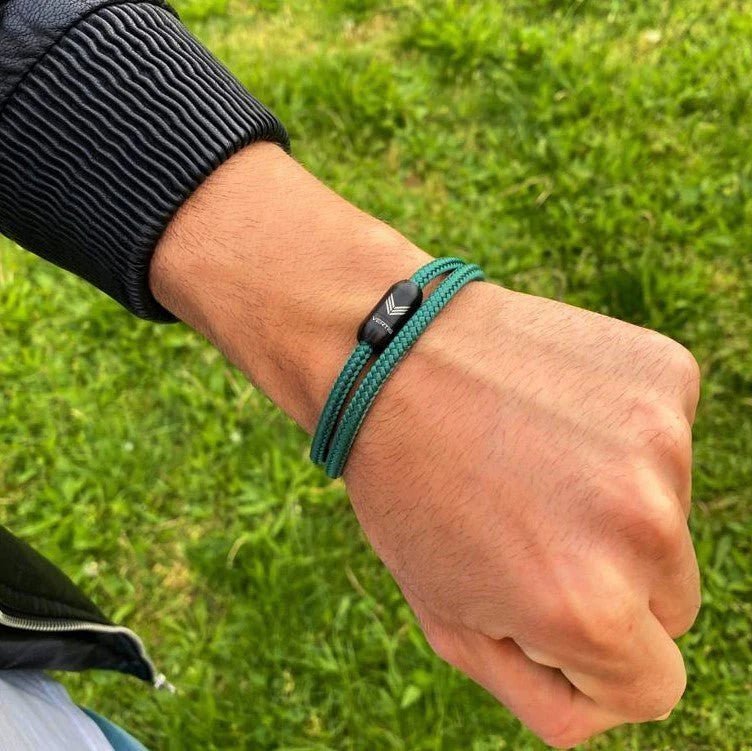 Vertig Magnetic Nautical Paracord Bracelet Green on a man&#39;s wrist. Adds an earthy, sporty statement.