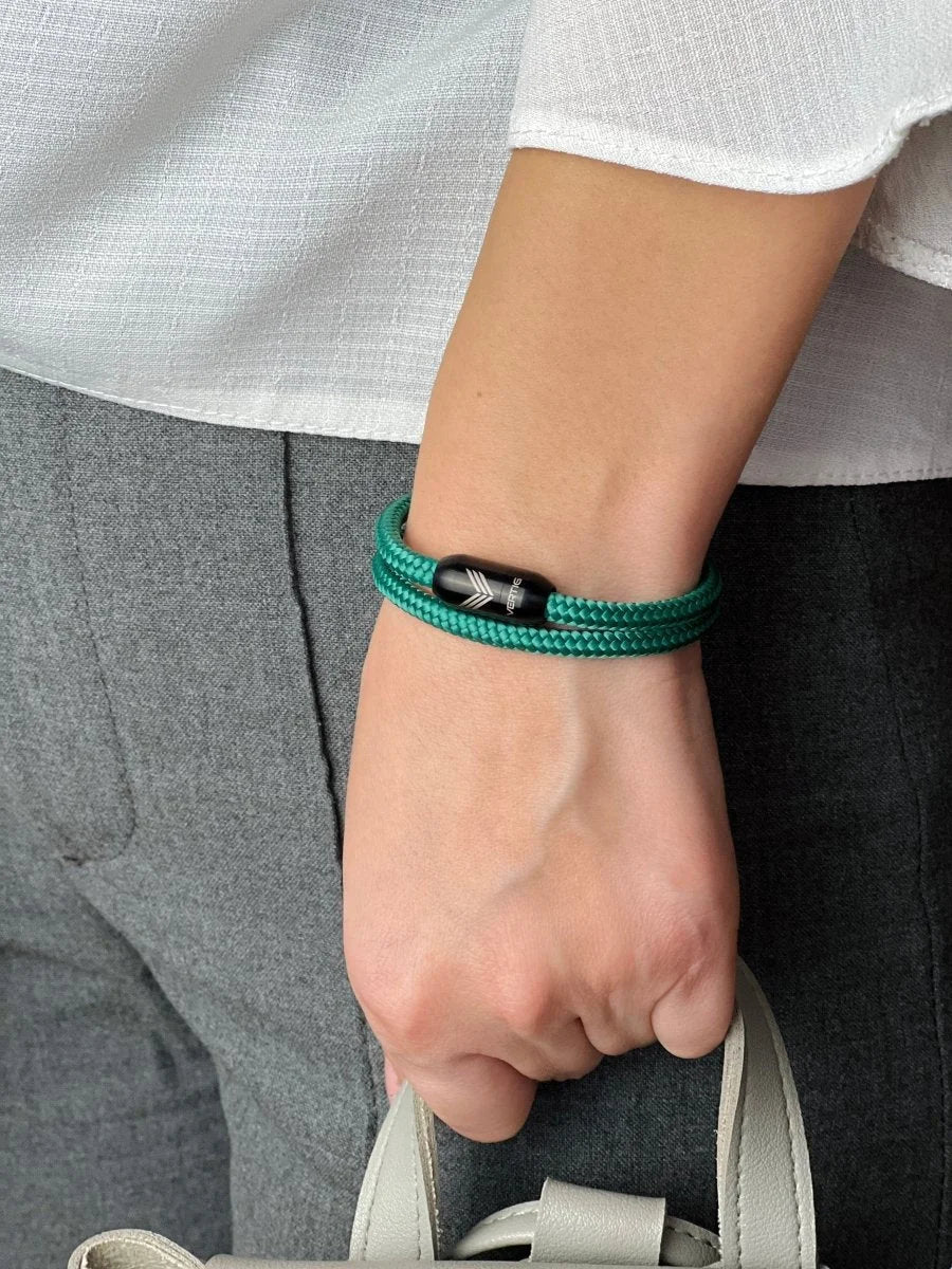 Vertig Magnetic Nautical Paracord Bracelet Green on a woman&#39;s arm. Comfortable fit, highlighting its unique shade.