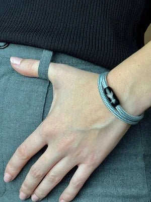Vertig Magnetic Nautical Paracord Bracelet Grey on a woman&#39;s arm. Comfortable fit, highlighting its sophisticated hue.