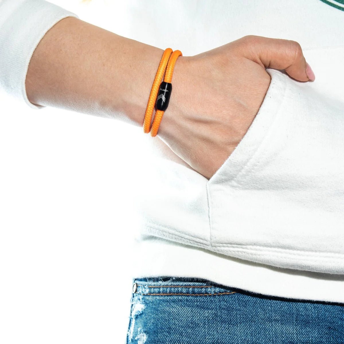 Vertig Magnetic Nautical Paracord Bracelet Orange on a woman&#39;s wrist. A striking accessory for a vibrant look.