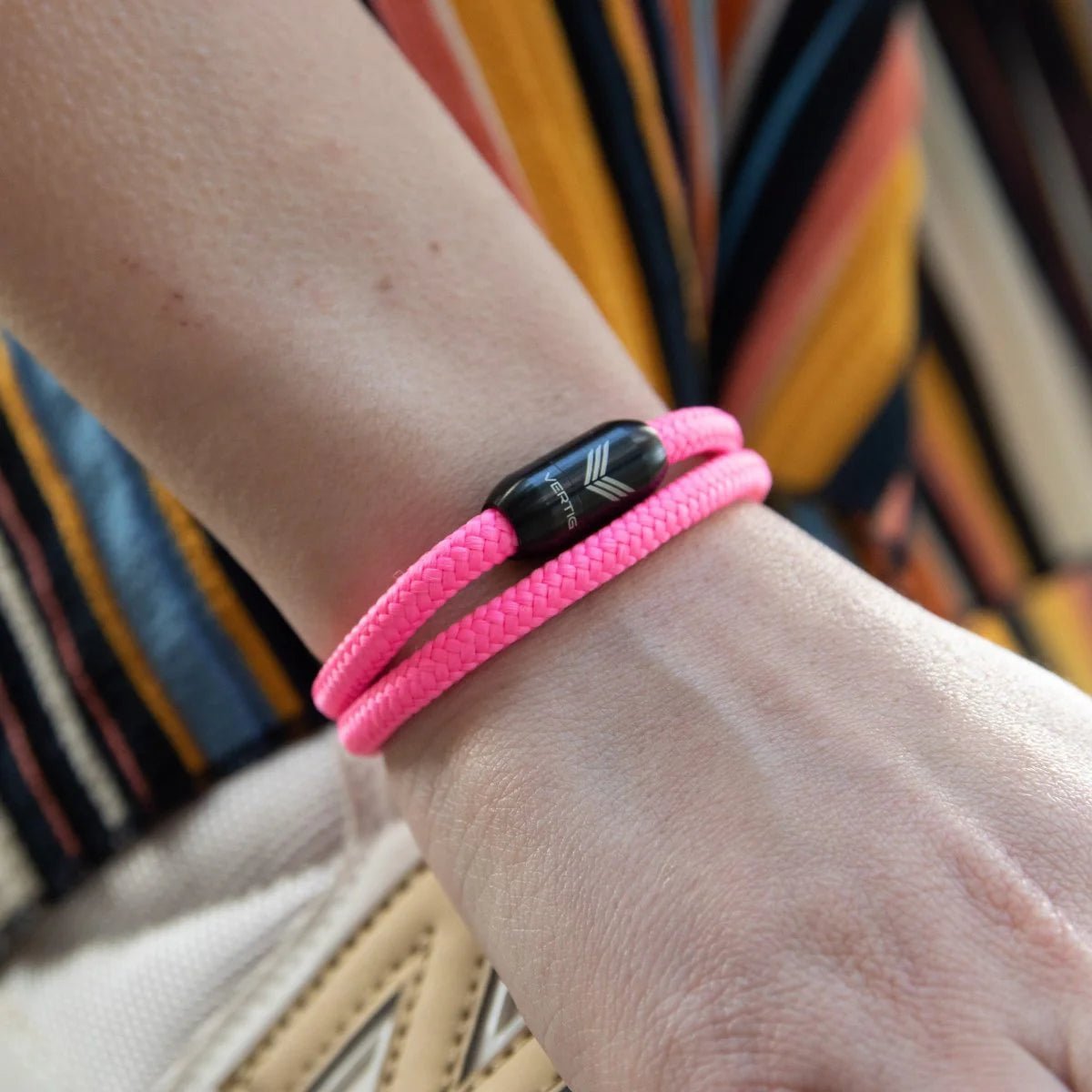 Vertig Magnetic Nautical Paracord Bracelet Pink on a woman&#39;s forearm. Comfortable design, perfect for subtle elegance.