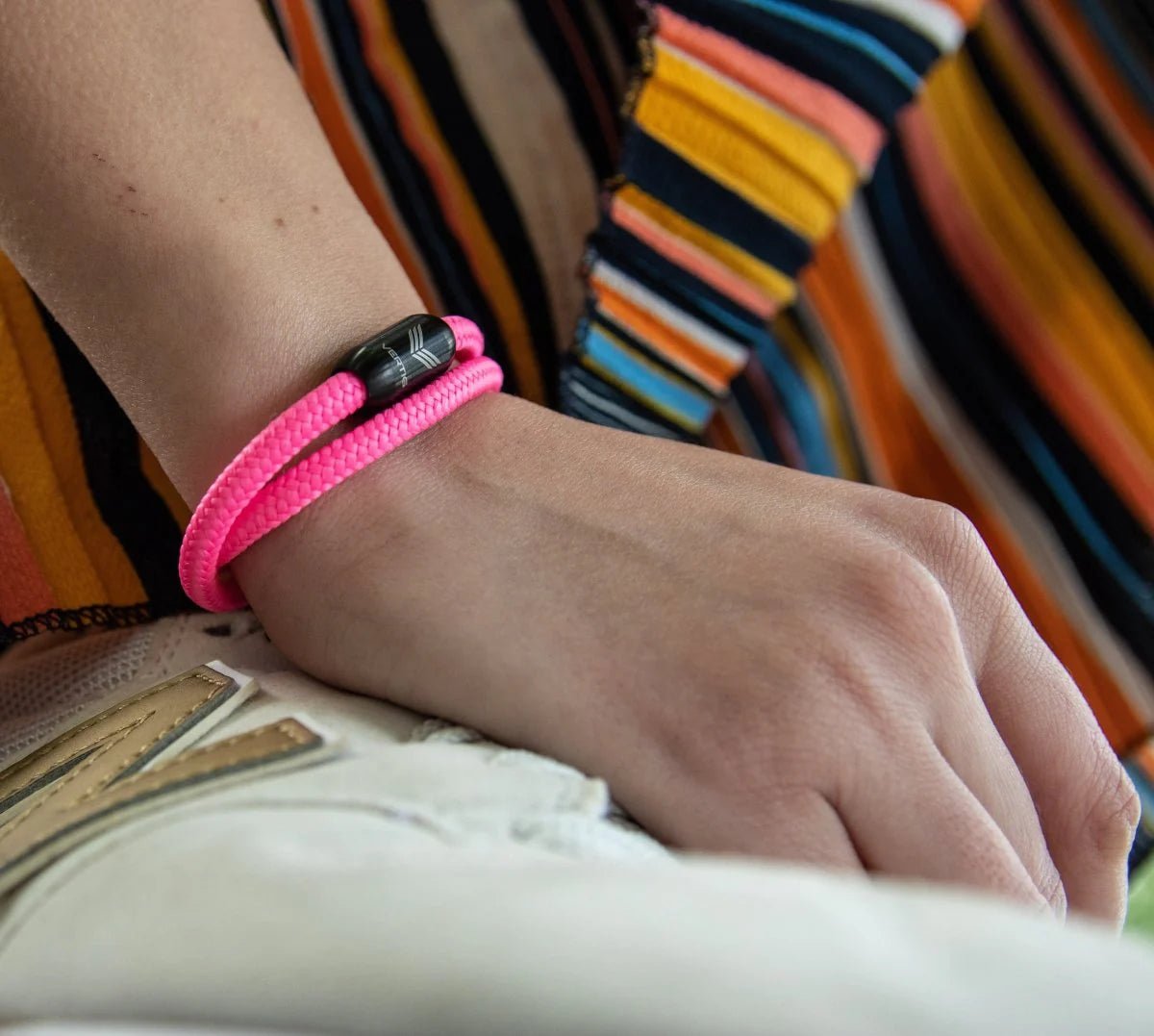 Vertig Magnetic Nautical Paracord Bracelet Pink on a woman&#39;s wrist. Adds a delicate, fashionable statement.