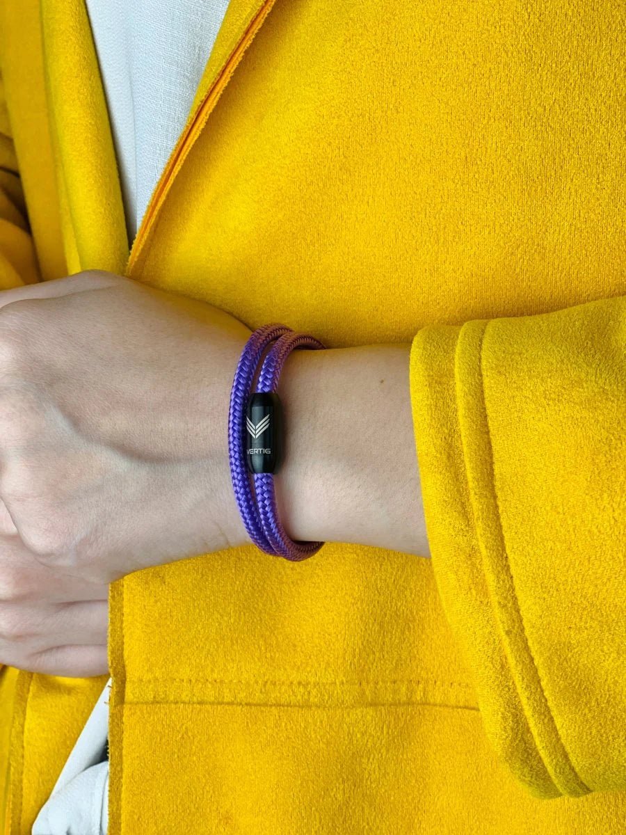 Vertig Magnetic Nautical Paracord Bracelet Purple on a woman's wrist. A striking accessory for a sophisticated look.