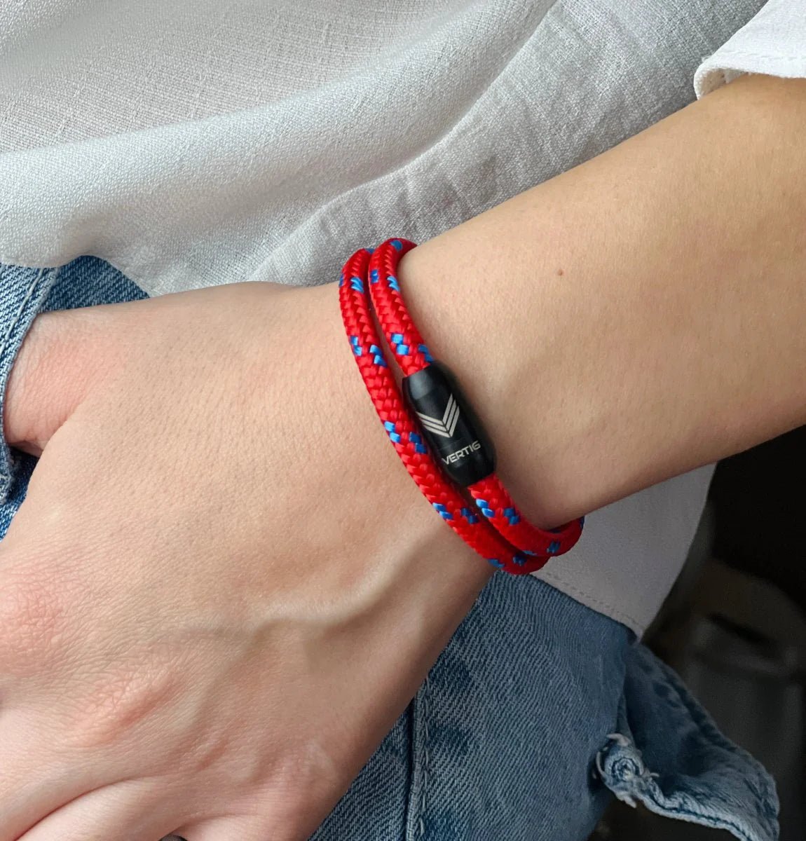 Vertig Magnetic Nautical Paracord Bracelet Red Blue on a woman&#39;s wrist. Stylish, durable outdoor accessory.