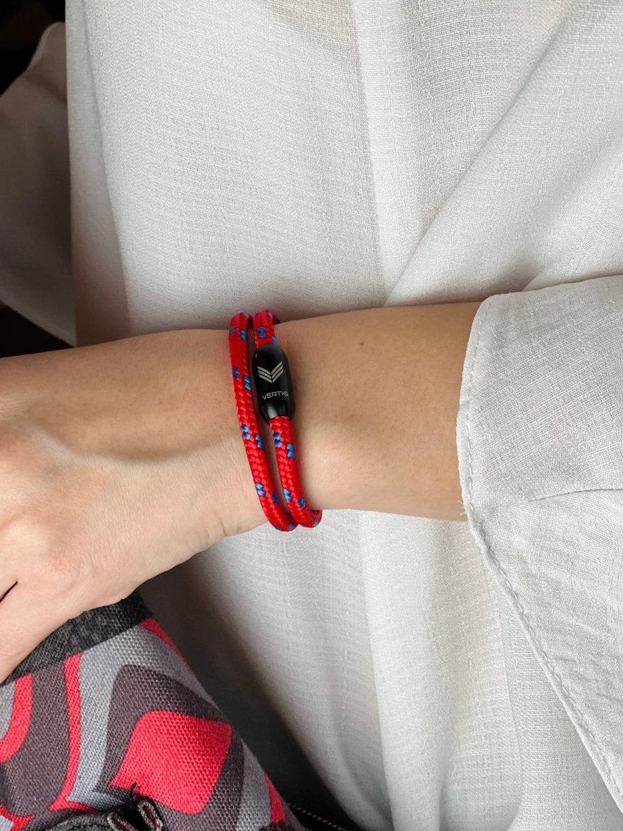 Vertig Magnetic Nautical Paracord Bracelet Red Blue on a woman&#39;s wrist. Fashionable red and blue accessory.