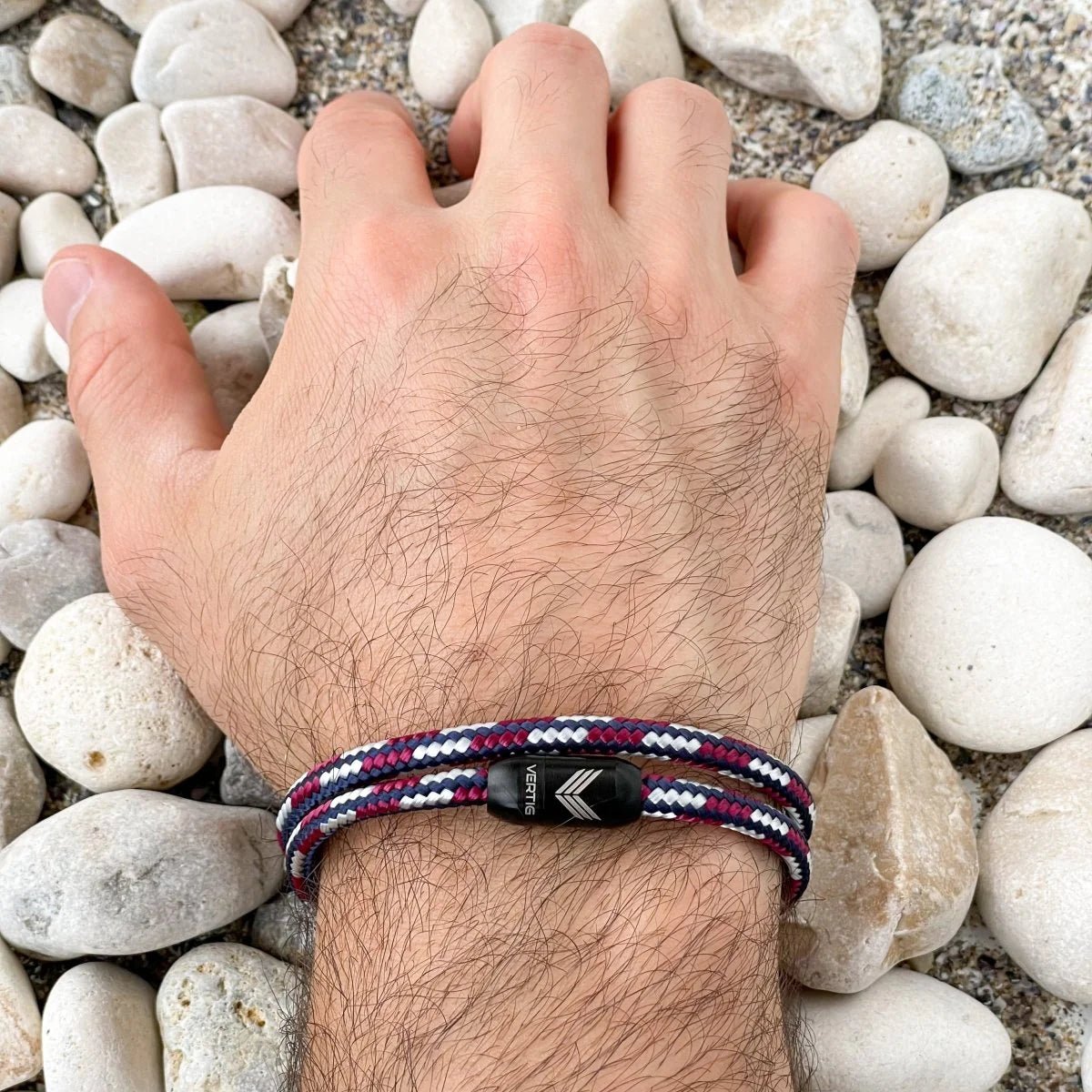 Vertig Magnetic Nautical Paracord Bracelet Red White on a man&#39;s wrist. Adds a sporty, maritime statement.