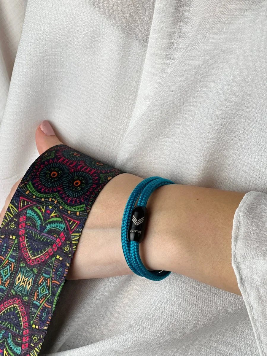 Vertig Magnetic Nautical Paracord Bracelet Turquoise on a woman&#39;s arm. Comfortable fit, highlighting its unique shade.