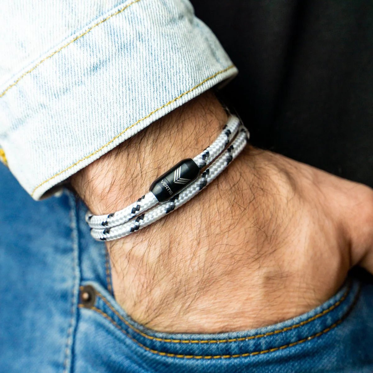 Vertig Magnetic Nautical Paracord Bracelet White Black on a man&#39;s wrist. Adds a sleek, timeless statement to any outfit.