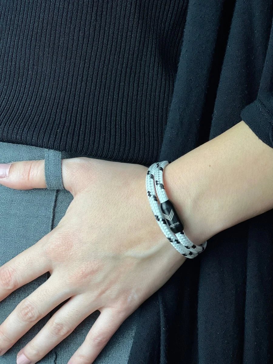 Vertig Magnetic Nautical Paracord Bracelet White Black on a woman&#39;s arm. Comfortable fit highlighting the distinct weave pattern.