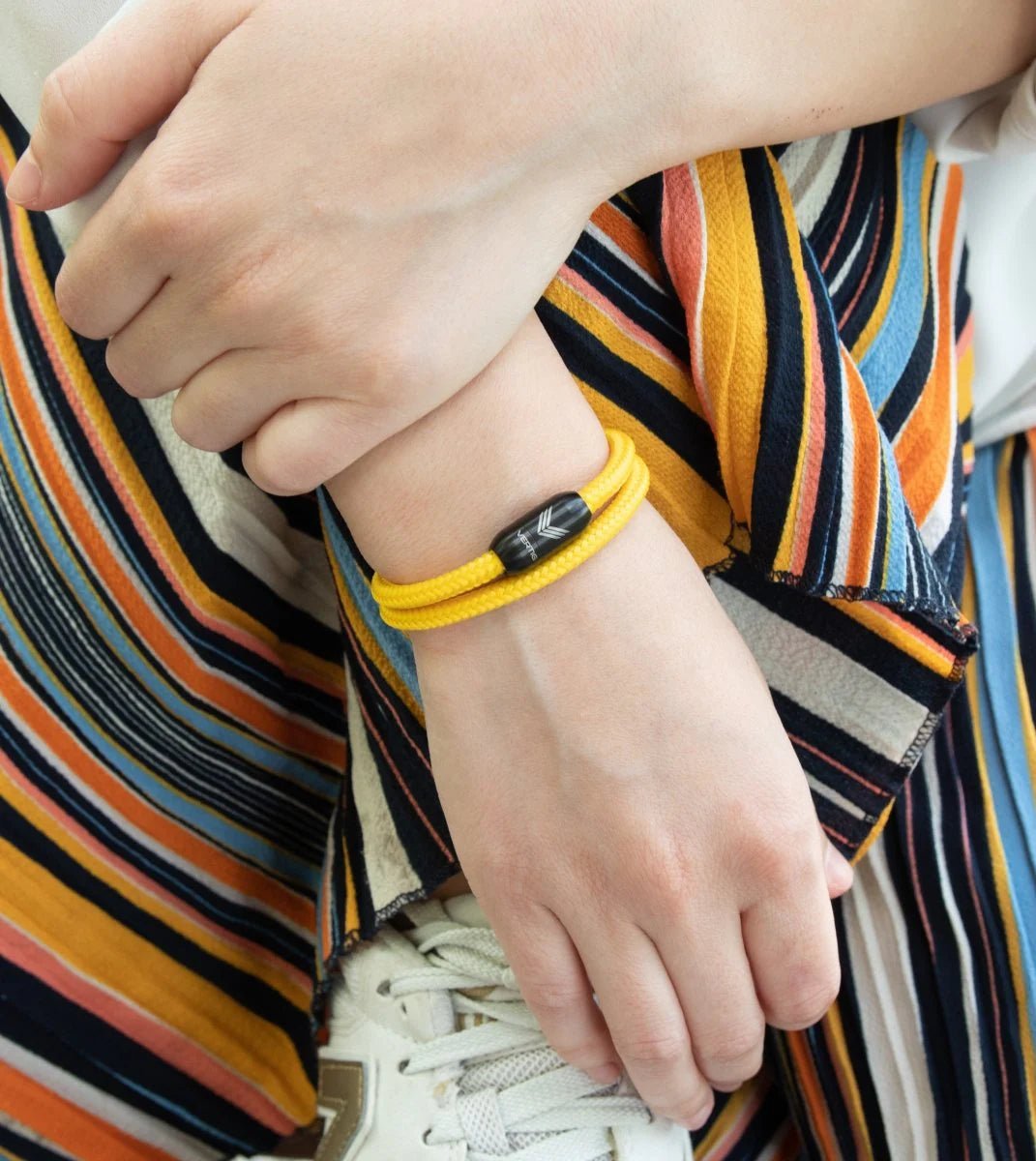 Vertig Magnetic Nautical Paracord Bracelet Yellow on a woman&#39;s forearm. Features bright solid yellow rope.