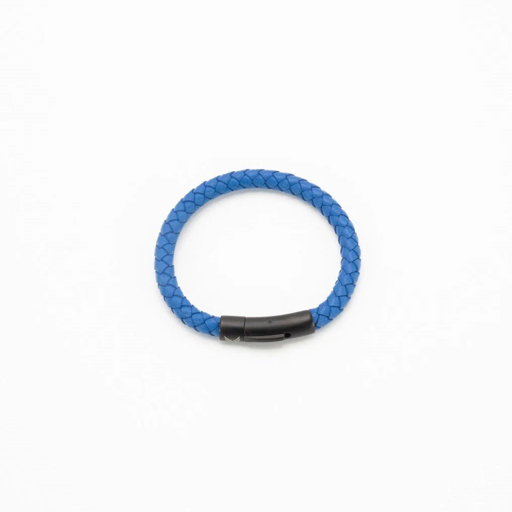 Vertig Leather Bracelet Blue clasped. Demonstrates the seamless and elegant fit of its sleek clasp on the wrist.