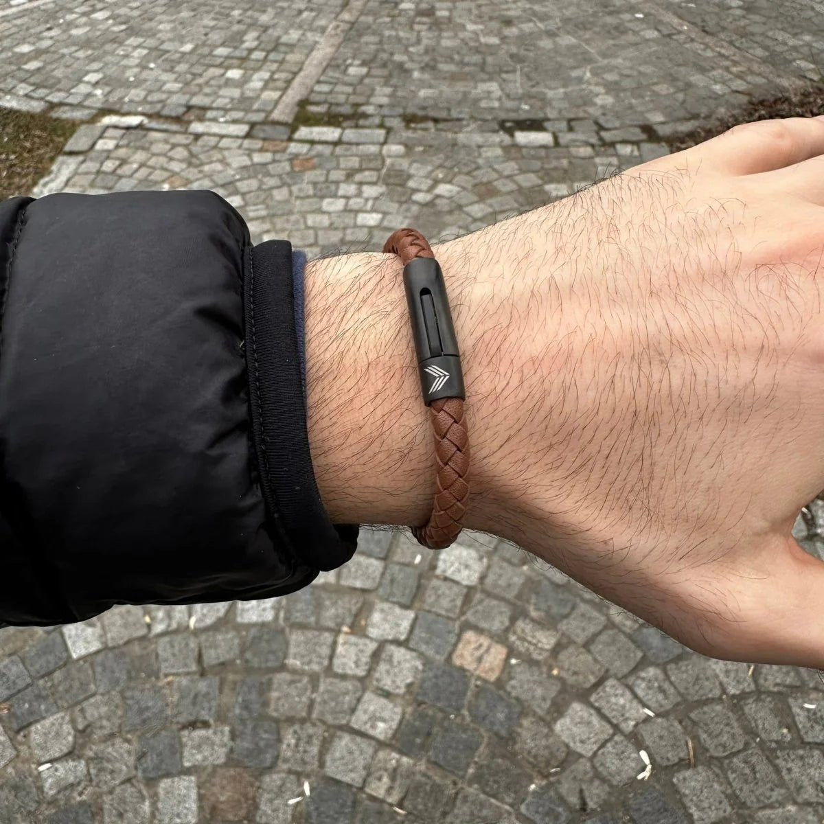 Vertig Magnetic Wide Leather Bracelet Brown on a man&#39;s wrist. Accentuates masculine style with its versatile brown leather band.