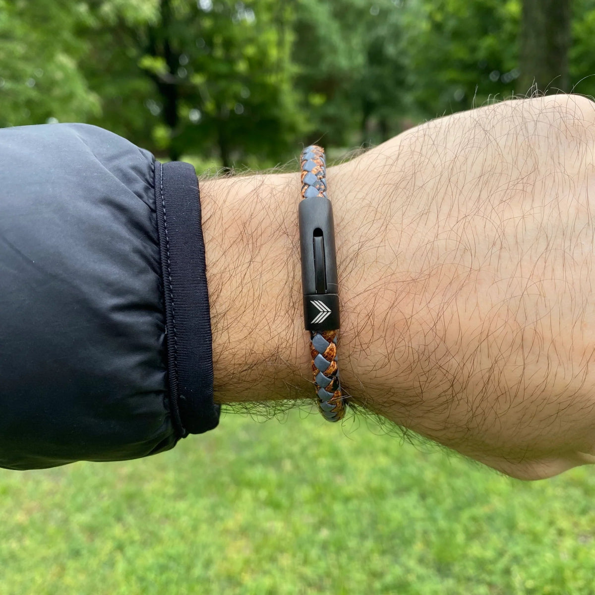 Vertig Leather Bracelet Vintage Bronze on a man&#39;s wrist. Accentuates rugged elegance with its distinct vintage hue and secure fit.