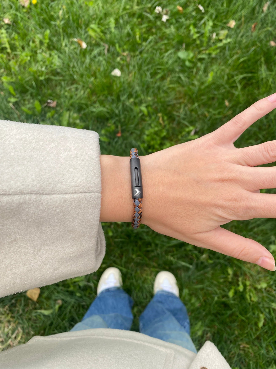Vertig Leather Bracelet Vintage Bronze on a woman&#39;s wrist. Adds a touch of earthy sophistication, emphasizing its slender form and rich coloring.