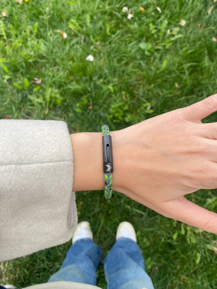 Vertig Leather Bracelet Vintage Green on a woman's wrist. Adds a touch of warm elegance, emphasizing its slender form and deep coloring.