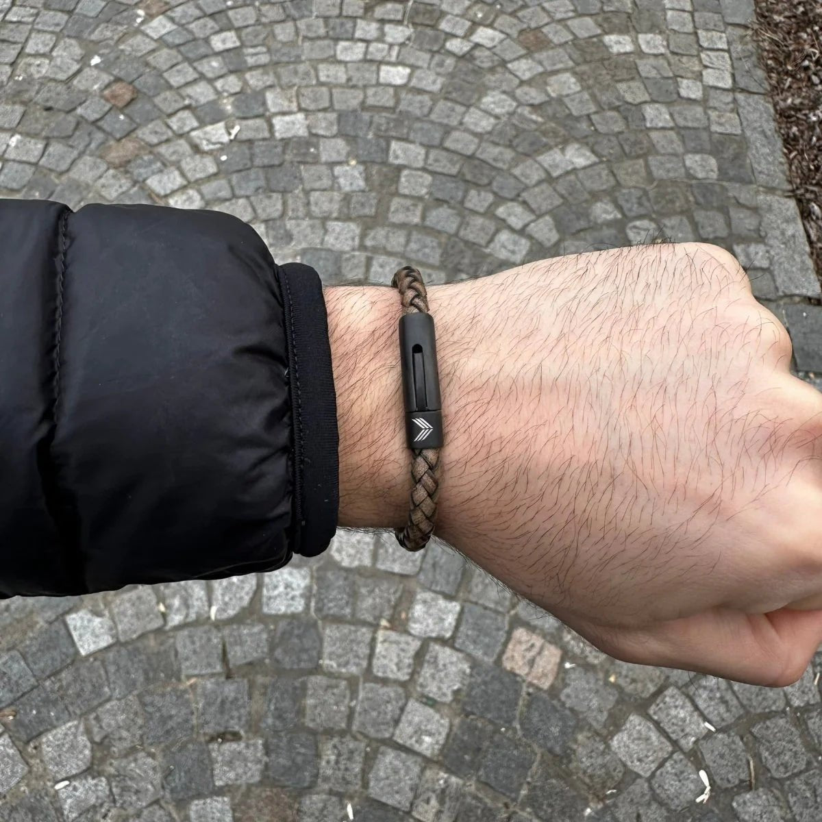 Vertig Leather Bracelet Vintage White on a man&#39;s wrist. Accentuates sophisticated style with its distinct vintage hue and secure clasp.