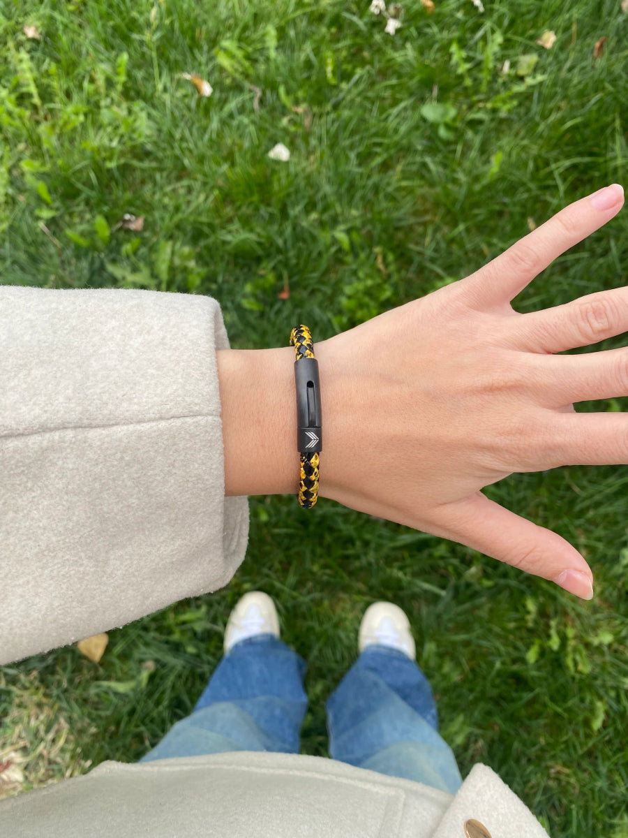 Vertig Leather Bracelet Vintage Yellow on a woman&#39;s wrist. Adds a touch of warm elegance, emphasizing its slender form and rich coloring.