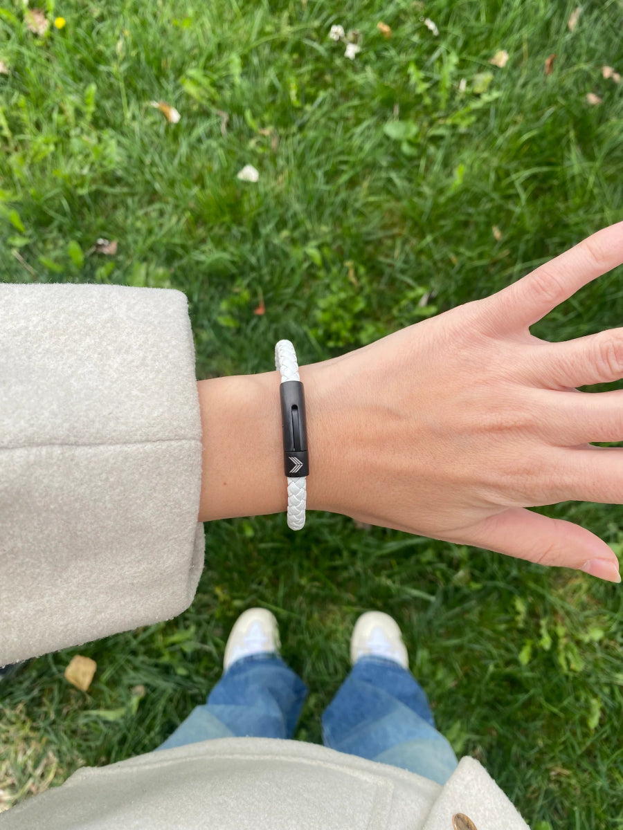 Vertig Leather Bracelet White on a woman&#39;s wrist. Adds a sophisticated touch, emphasizing its slender profile and pure white hue.