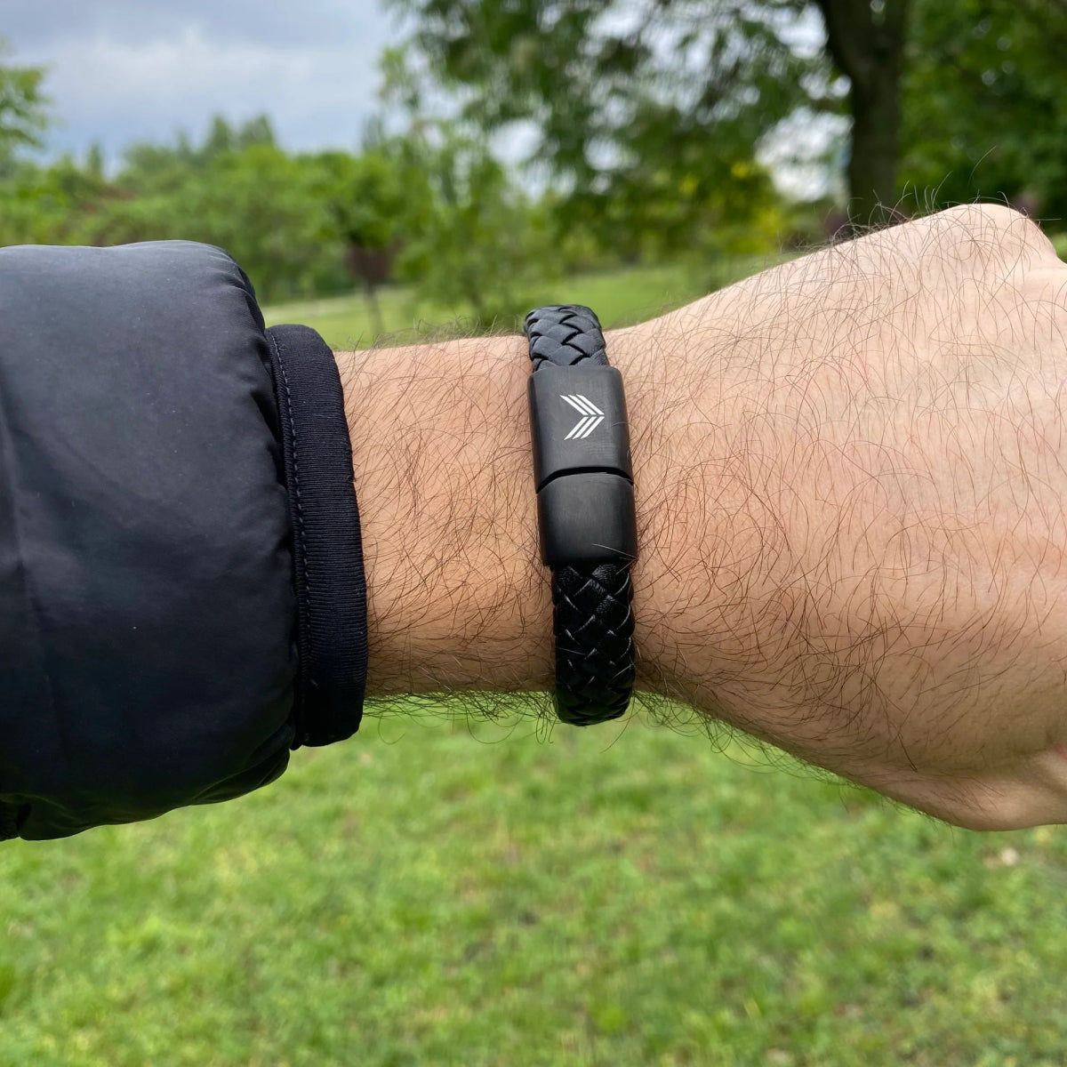 Vertig Magnetic Wide Leather Bracelet Black on a man&#39;s forearm. Highlights its comfortable fit and the rich texture of the genuine black leather.