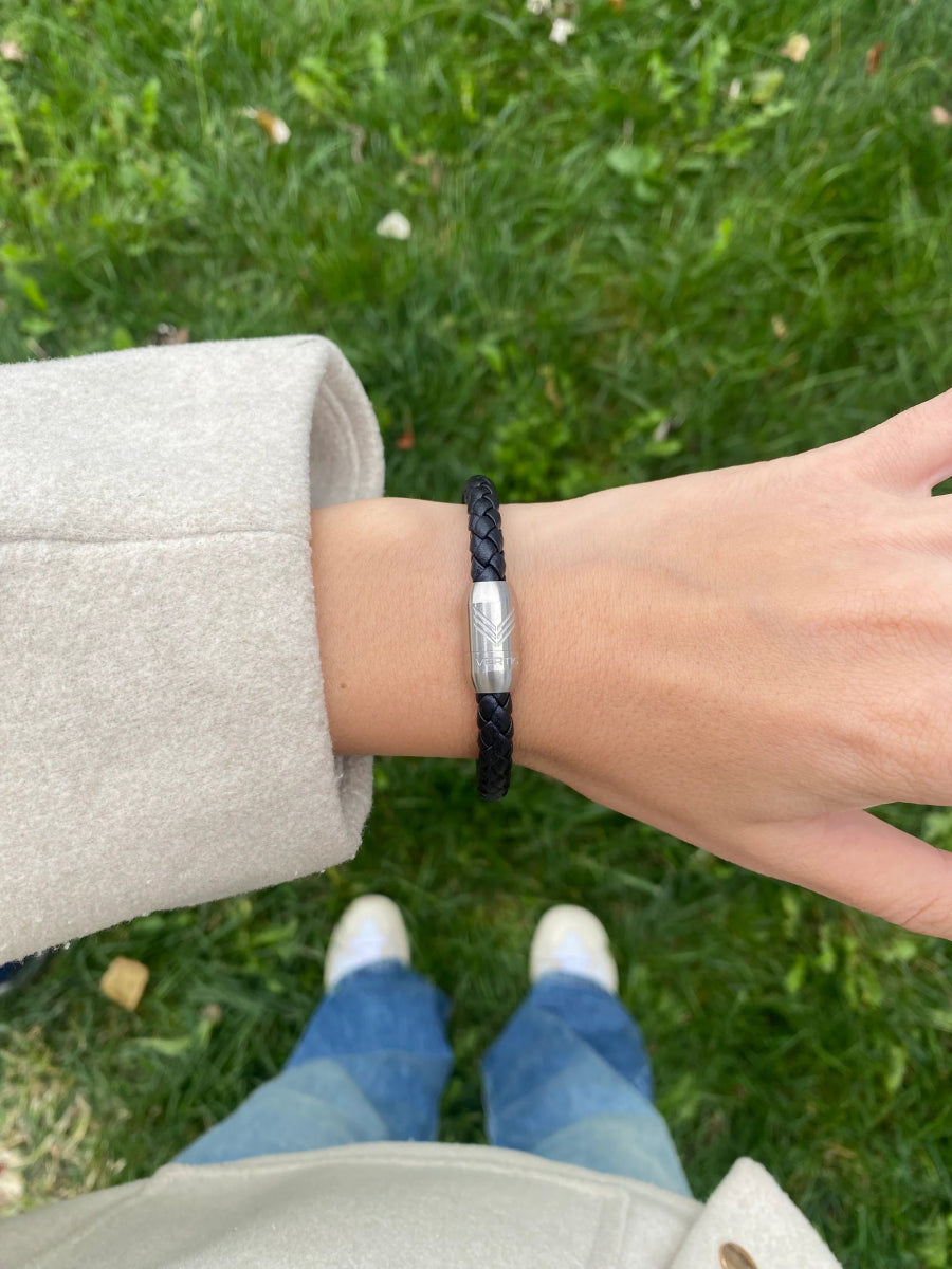 Vertig Magnetic Leather Bracelet Black (Slim) on a woman&#39;s wrist. Adds a sophisticated touch, highlighting its slender profile and genuine leather.