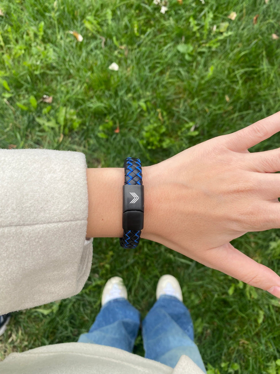 Vertig Magnetic Wide Leather Bracelet Black-Blue on a woman&#39;s wrist. Adds a confident, contemporary touch with its bold design.