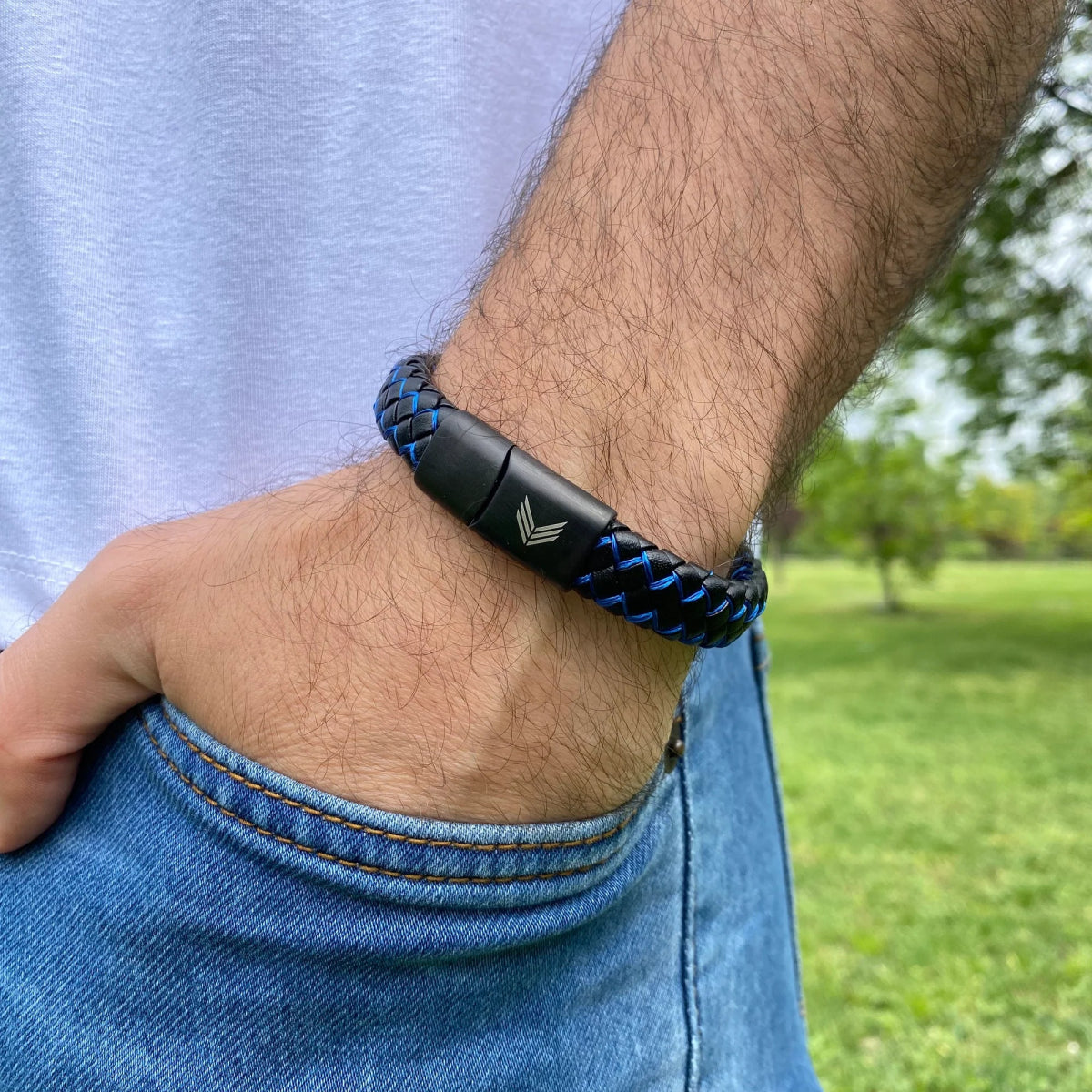 Vertig Magnetic Wide Leather Bracelet Black-Blue on a man&#39;s forearm. Highlights the premium texture of genuine leather and its unique color combination.