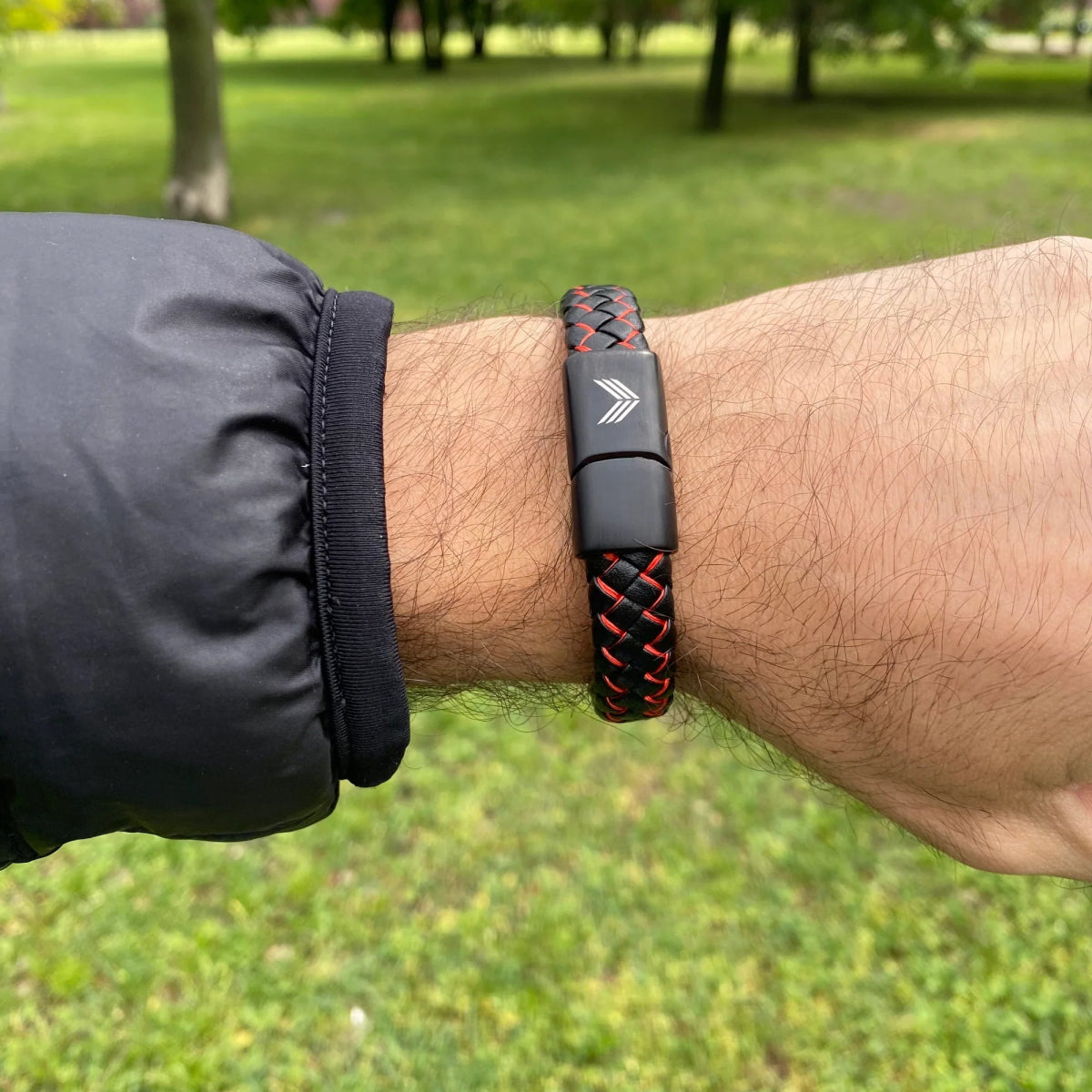 Vertig Magnetic Wide Leather Bracelet Black-Red on a man&#39;s forearm. Highlights the premium texture of genuine leather and its unique color combination.