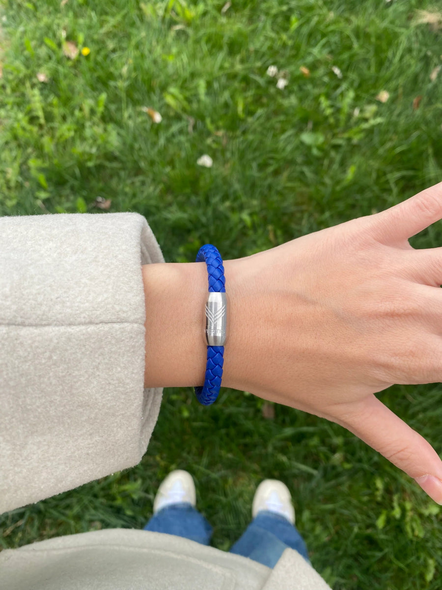 Vertig Magnetic Leather Bracelet Blue (Slim) on a woman&#39;s wrist. Adds a refined touch, highlighting its slender profile and genuine blue leather.