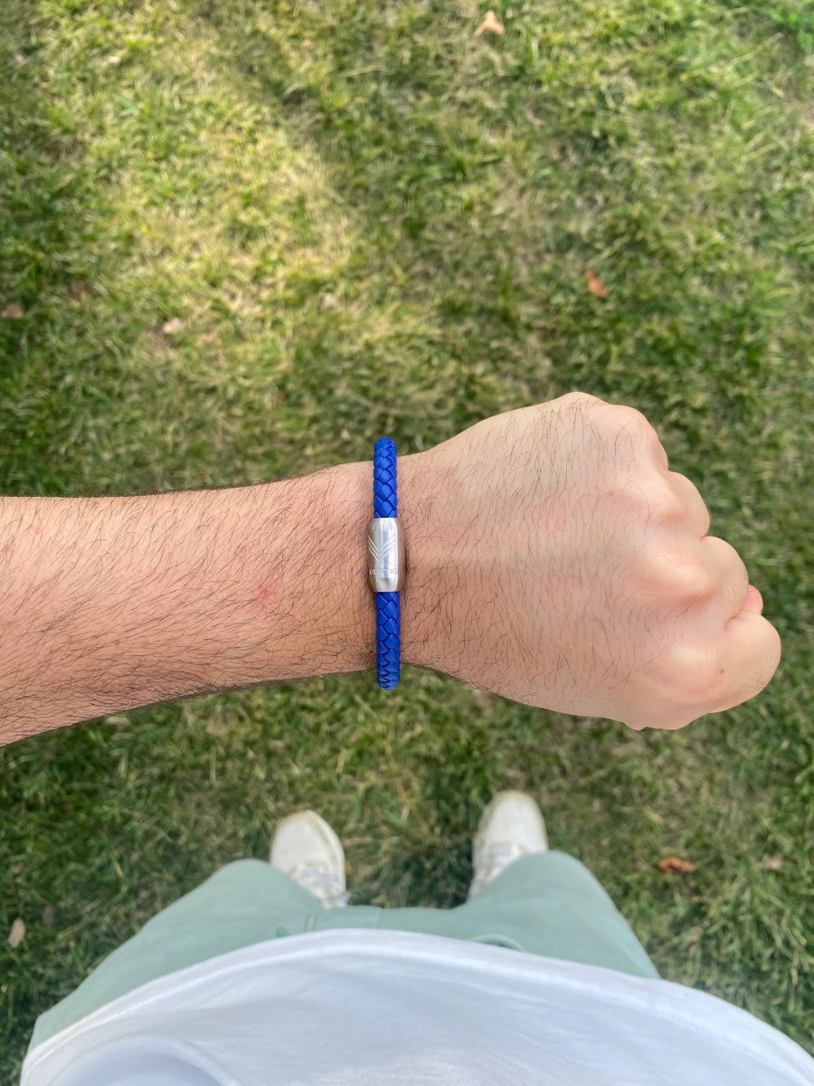 Vertig Magnetic Leather Bracelet Blue (Slim) on a man&#39;s wrist. Accentuates sophisticated style with its sleek blue leather and secure magnetic clasp.