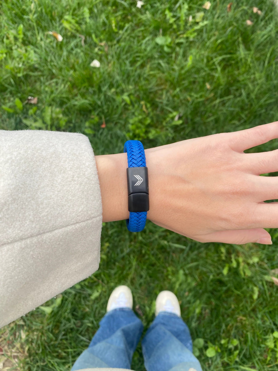 Vertig Magnetic Wide Leather Bracelet Blue on a woman&#39;s wrist. Creates an edgy, confident statement with its wide, deep blue leather.
