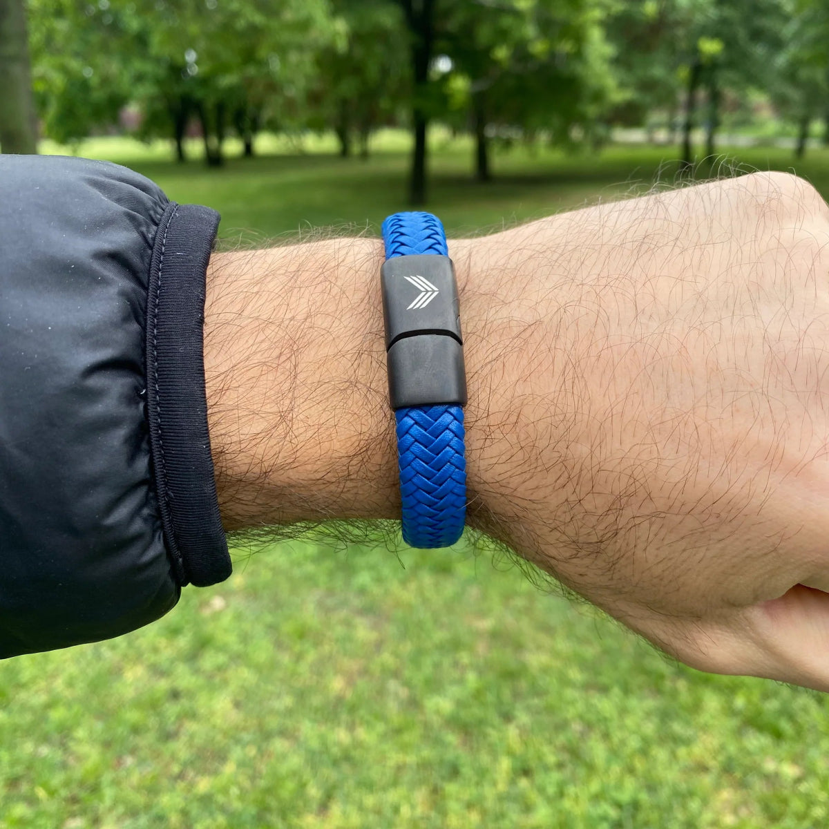 Vertig Magnetic Wide Leather Bracelet Blue on a man&#39;s forearm. Showcases the premium texture of genuine blue leather and comfortable wear.