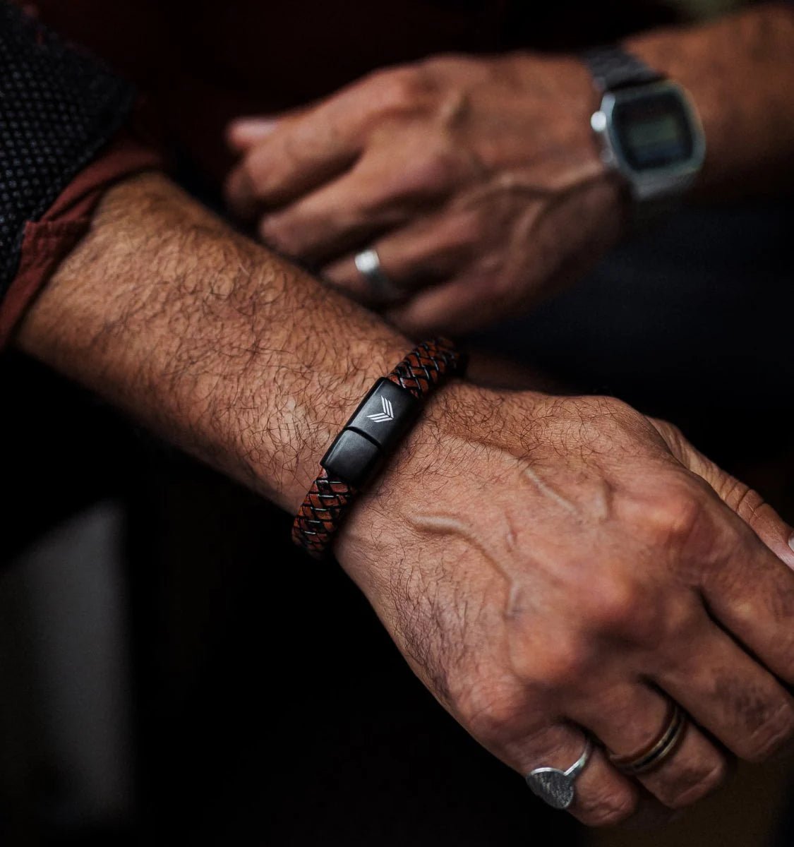 Vertig Magnetic Wide Leather Bracelet Brown on a man&#39;s wrist. Accentuates masculine style with its versatile brown leather band.