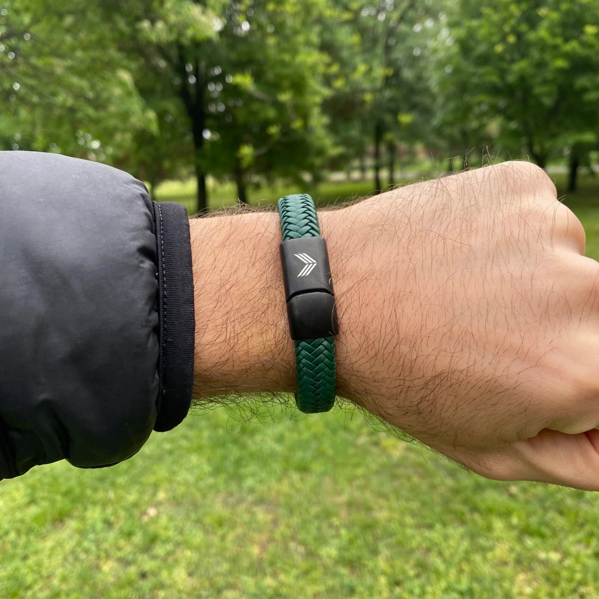 Vertig Magnetic Wide Leather Bracelet Green on a man&#39;s wrist. Accentuates rugged style with its bold leather band and natural tone.