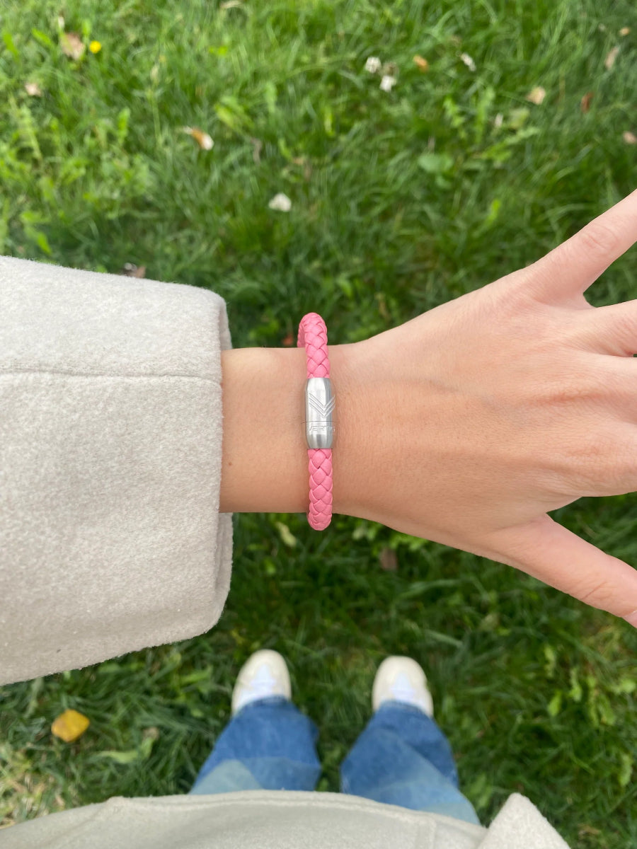 Vertig Magnetic Leather Bracelet Pink (Slim) on a woman&#39;s wrist. Adds a refined touch, highlighting its slender profile and genuine pink leather.